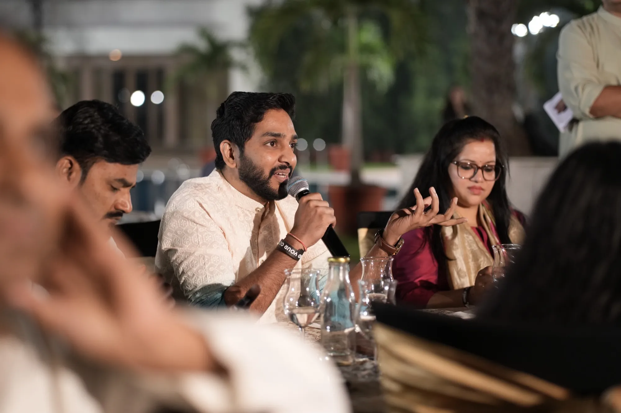 A founder speaking into the mic at a panel table