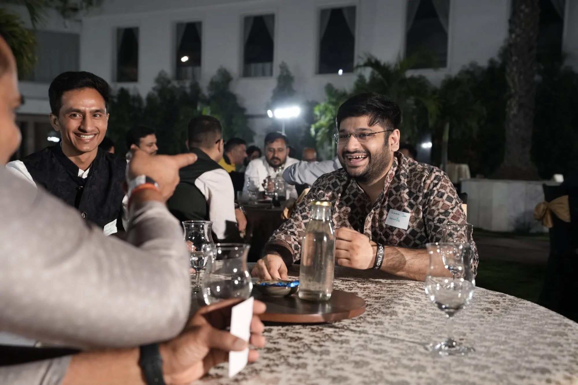 Guests laughing together at a round table
